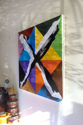 Colourful geometric abstract painting with loosely brushed “X” on top.