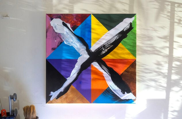 Colourful geometric abstract painting with loosely brushed “X” on top.