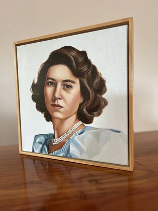 This painting is a realistic portrait of a young Princess Elizabeth, showcasing her composed expression, wavy brown hair, and elegant attire with a pearl necklace.