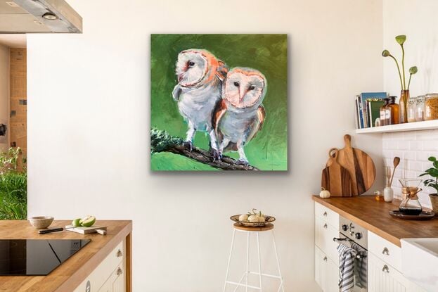 two barn owls on a branch