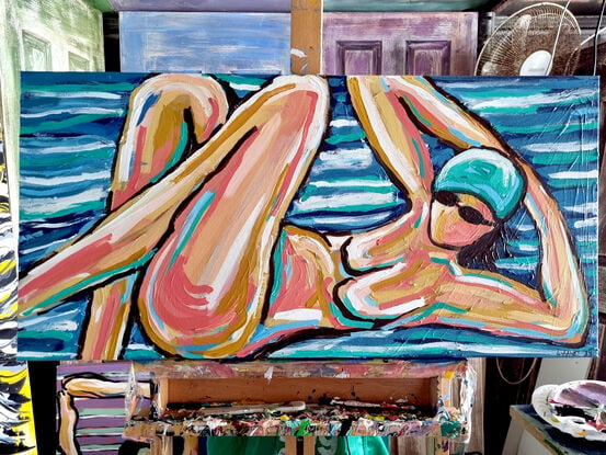 A woman in abstract way on a beach towel 