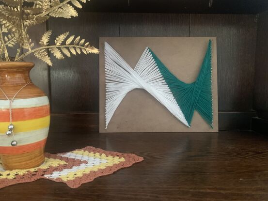 Creating special string art in a piece of wood