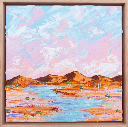 Pink and blue sky with peach toned ranges, tiny trees and a water way through the outback. 