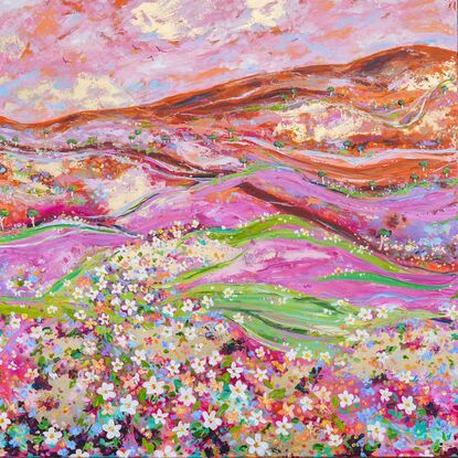 Foreground of wildflowers in a variety of colours in a hilly landscape of pink green and orange with flying birds overhead. 