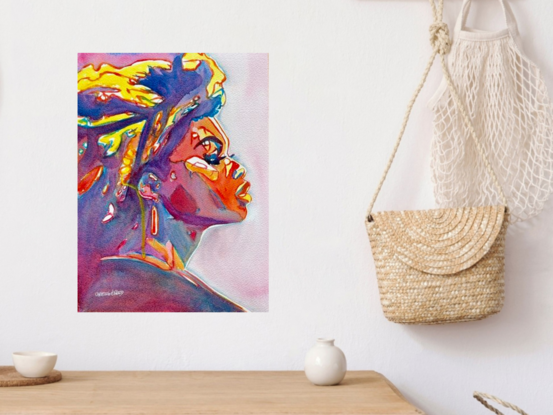 "Vibrant Ascend" is a powerful and dynamic watercolor portrait that captures the striking profile of a woman, bathed in a spectrum of bold, vivid colors. The artwork radiates energy and strength, with the rich interplay of deep blues, fiery reds, and bright yellows creating a sense of movement and intensity. The detailed expression and upward gaze of the subject suggest a journey of empowerment and resilience. This contemporary piece is a celebration of color and form, making it an eye-catching addition to any art collection.