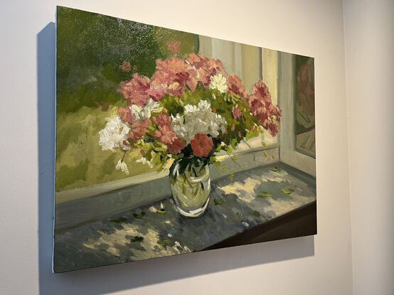 Pink and white flowers on windowsill