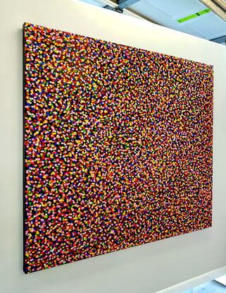 thousands of rainbow dots on black canvas