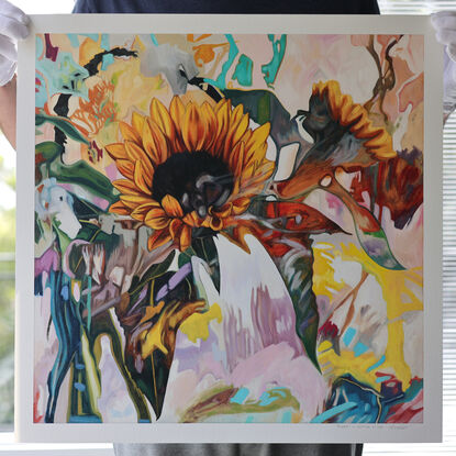 Picture of a sunflower painted in an abstract expressionistic style. The flower is surrounded by leaves that blend into abstract shapes and patterns. The image is warm and fluid with neutral earthy tones combined with yellows and pinks.