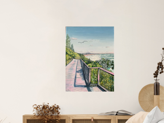 Beach boardwalk along the coast, framed by pandanus and coastal shrubs, seagulls overhead and views in distance,