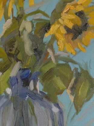 A painting of sunflowers in a clear glass vase. The sunflowers have bright yellow petals and dark brown centers, with green leaves surrounding them. The brushstrokes are loose and expressive, giving the flowers a sense of movement. The background is a soft blue, and the table is a warm, light brown. The glass vase reflects light with subtle, soft blue and gray tones, adding depth and texture to the painting. The overall feel is bright, cheerful, and inviting.