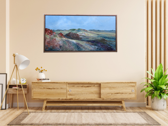 Painting of a multi-coloured desert with a wide view of a stunning landscape