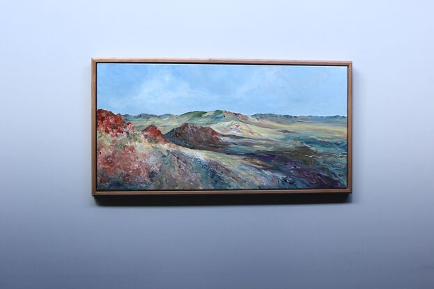 Painting of a multi-coloured desert with a wide view of a stunning landscape