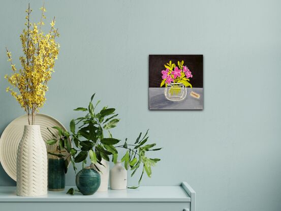 Purple flowers in a glass vase with green leaves on a background of dark paynes grey and light paynes grey. The word Gratitude is collaged onto the right side of the painting