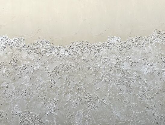 A neutral beige background with the bottom 3/4 covered with semi-transparent textured sea foam.