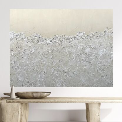 A neutral beige background with the bottom 3/4 covered with semi-transparent textured sea foam.