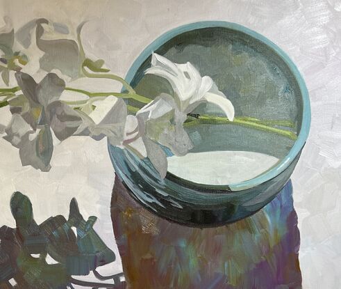 
White orchids in turquoise tea bowl
