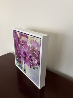 Purple Singapore Orchids in glass vase with reflections