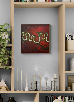 A vibrant and textured aerial landscape titled 'The Red Land of Wonder'. The painting features a vivid red expanse with a river meandering horizontally across the canvas. Dark green trees are dotted along the river.