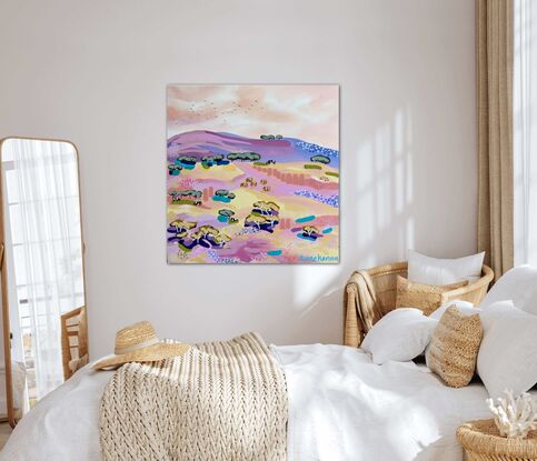 A view of distant cattle grazing in the pink, mango, lemon, and mauve fields under a warm summer afternoon sky.