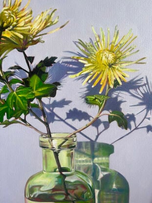 Chrysanthemums in green vase on patterns.