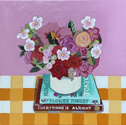 Flowers in vase on books