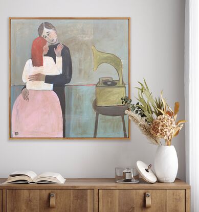 The painting depicts a man and woman embracing -- they are dancing. There is a gramophone on a stool beside them. 