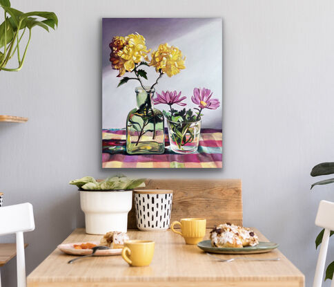 Yellow chrysanthemums on checked multicolored tea-towel. 