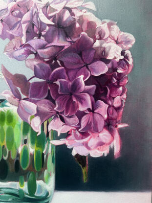 Giant purple hydrangea in green vase.