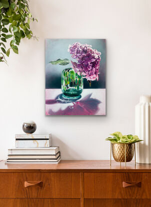 Giant purple hydrangea in green vase.