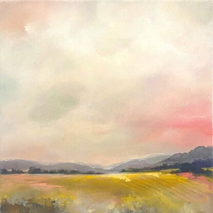 Golden summer fields under over warm skies filled with rosy clouds