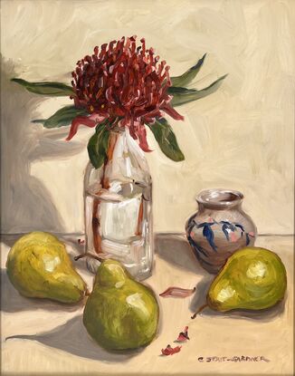 A red Waratah in a glass bottle surrounded by three pears and a small vase with blue and pink details