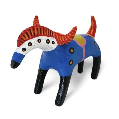 The Horned Wanderer sculpture features a bold blue body with vibrant red, curved horns and black legs, accented by colorful patterns and dotted details. 