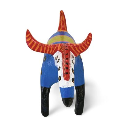 The Horned Wanderer sculpture features a bold blue body with vibrant red, curved horns and black legs, accented by colorful patterns and dotted details. 