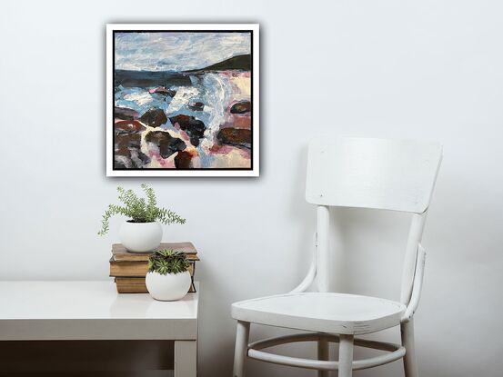 A coastal scene in pinks, purples, blues and greys, with rocks  in the foreground, a blue ocean, a dark headland and calm sky above. 