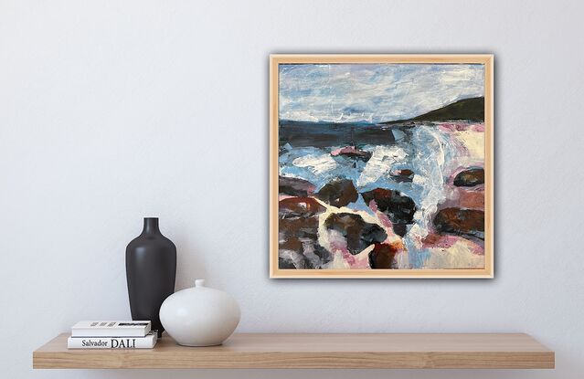 A coastal scene in pinks, purples, blues and greys, with rocks  in the foreground, a blue ocean, a dark headland and calm sky above. 