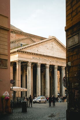 The Ancient Pantheon through a grungy street in Rome Italy