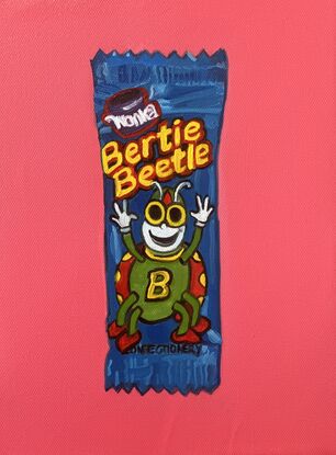 Bertie beetle sits on cerise background