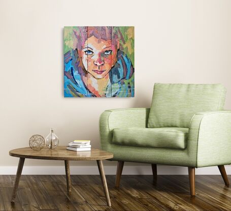 Brightly coloured face of young girl on 3 small canvases (triptych)