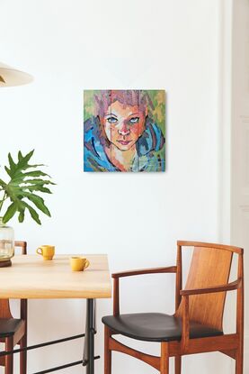 Brightly coloured face of young girl on 3 small canvases (triptych)