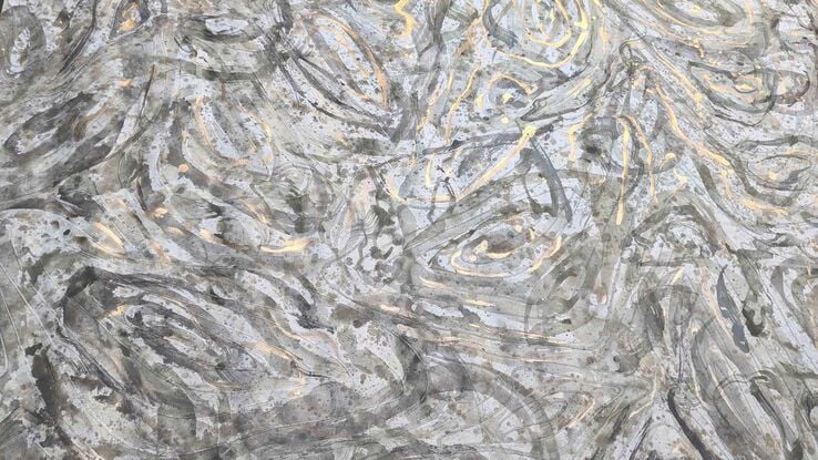 A large painting of a seaweed in a rockpool with metallic gold, soft green, beige, tan beige, black and white.