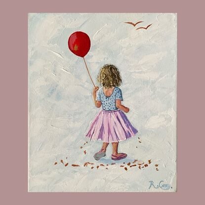 Little girl in pink tutu holding a red balloon.