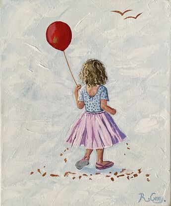 Little girl in pink tutu holding a red balloon.