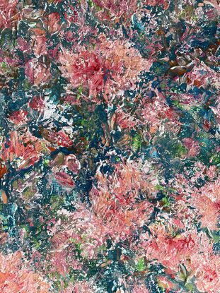 Pink and coral coloured flowers stand out predominantly over a blue and green background 