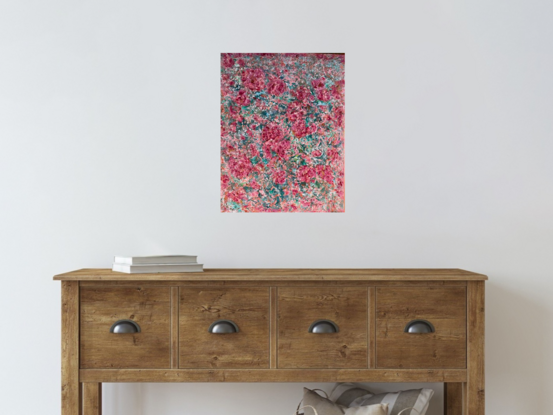 The textured pink and red coloured flowers stand out predominantly over  a green and turquoise  background.