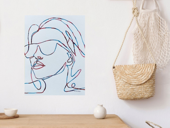 Introducing 'Silhouette,' a captivating watercolour artwork that elegantly captures the essence of modern minimalism with bold, flowing lines. This piece features a striking depiction of a woman in sunglasses, rendered in a continuous line style with red and blue hues that intertwine gracefully. The artwork exudes a sense of confidence and cool elegance, making it a perfect statement piece for contemporary interiors. 'Silhouette' invites the viewer to embrace simplicity and appreciate the beauty of form and expression.