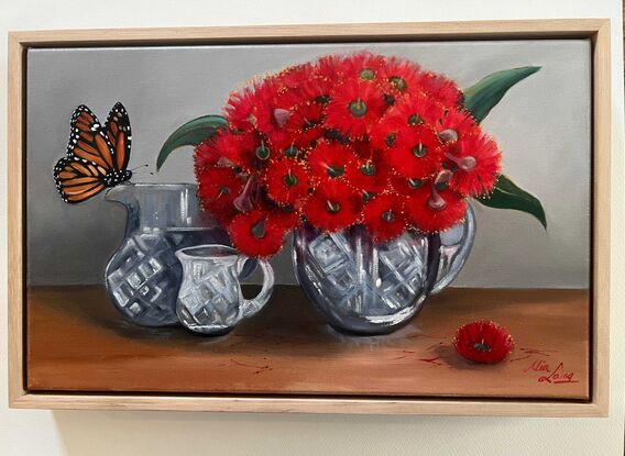 Monarch butterfly and crystal vases with red gum blossom. 