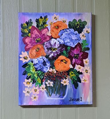 Orange pink blue flowers in a vase