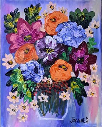 Orange pink blue flowers in a vase