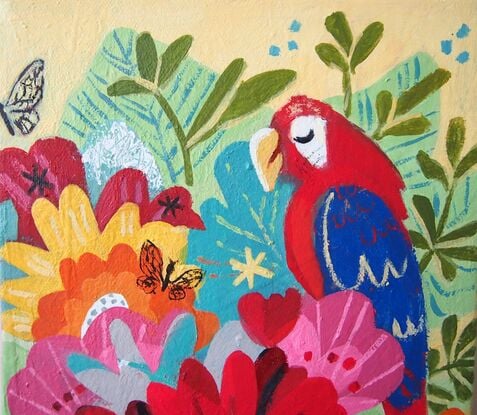 red parrot amidst a mix of large blossoms