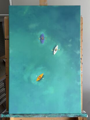 Aerial view of coloured kayaks on turquoise water